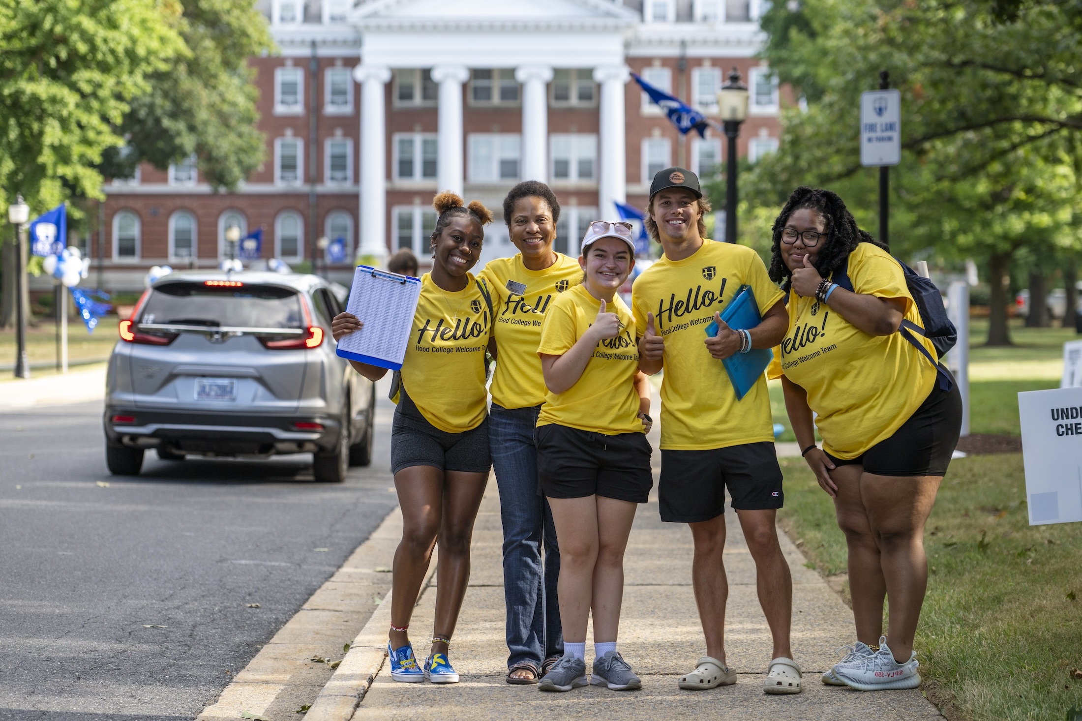 Students and staff give a thumbs up during Move-In Day 2023.