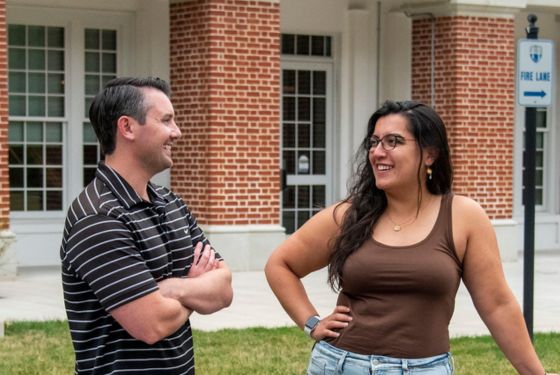 Man and woman talking outside of dorm