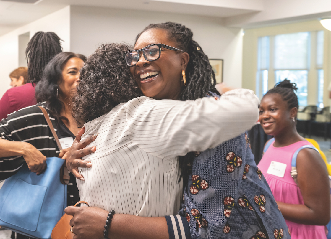 Hoda Zaki (left) embraces Aba Blankson (right)