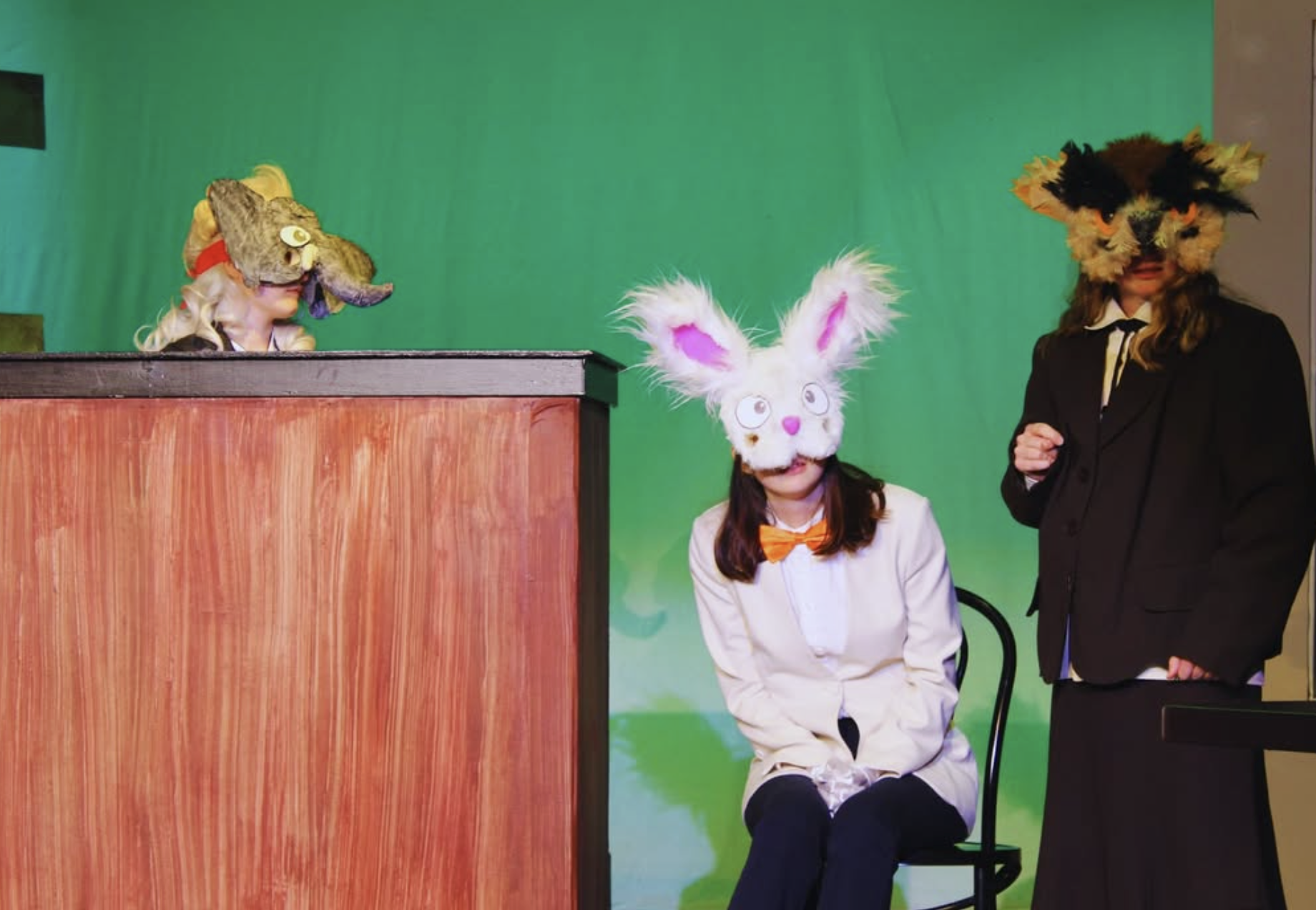 Students wearing handmade animal masks while performing in Beginnings '26.