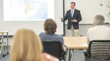 Student giving a presentation in a classroom