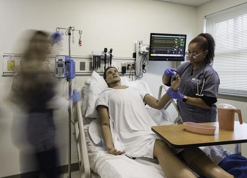 Hood College nursing students attend to a patient during a clinical simulation