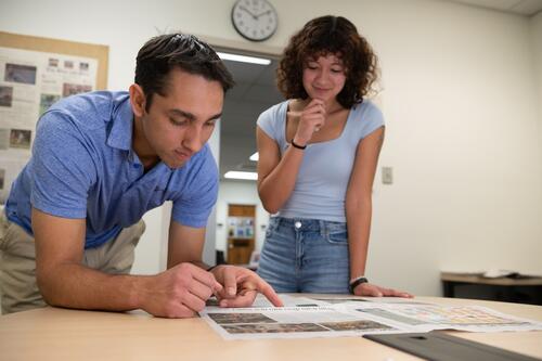 Amrit Brown and Sofia Montoya-Deck working on newspaper layout.