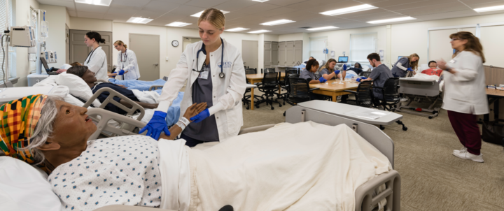 hood college nursing students work with SIM dolls